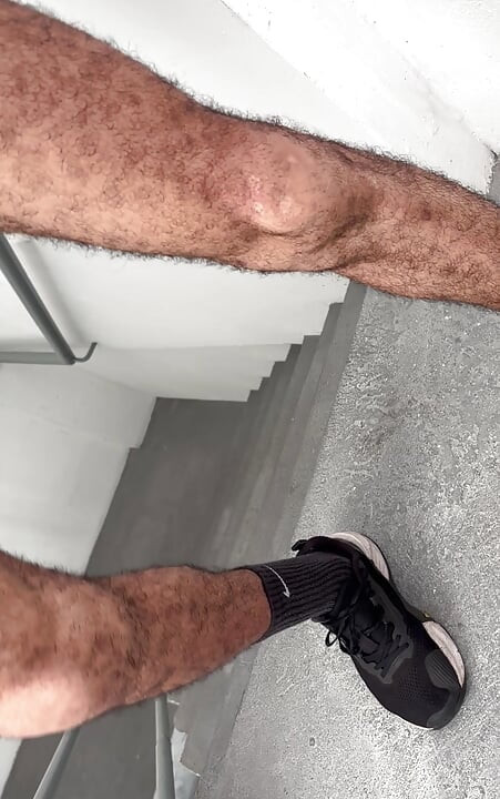 Hairy dad jerking off on the fire escape with a big hairy cock and cumming hard