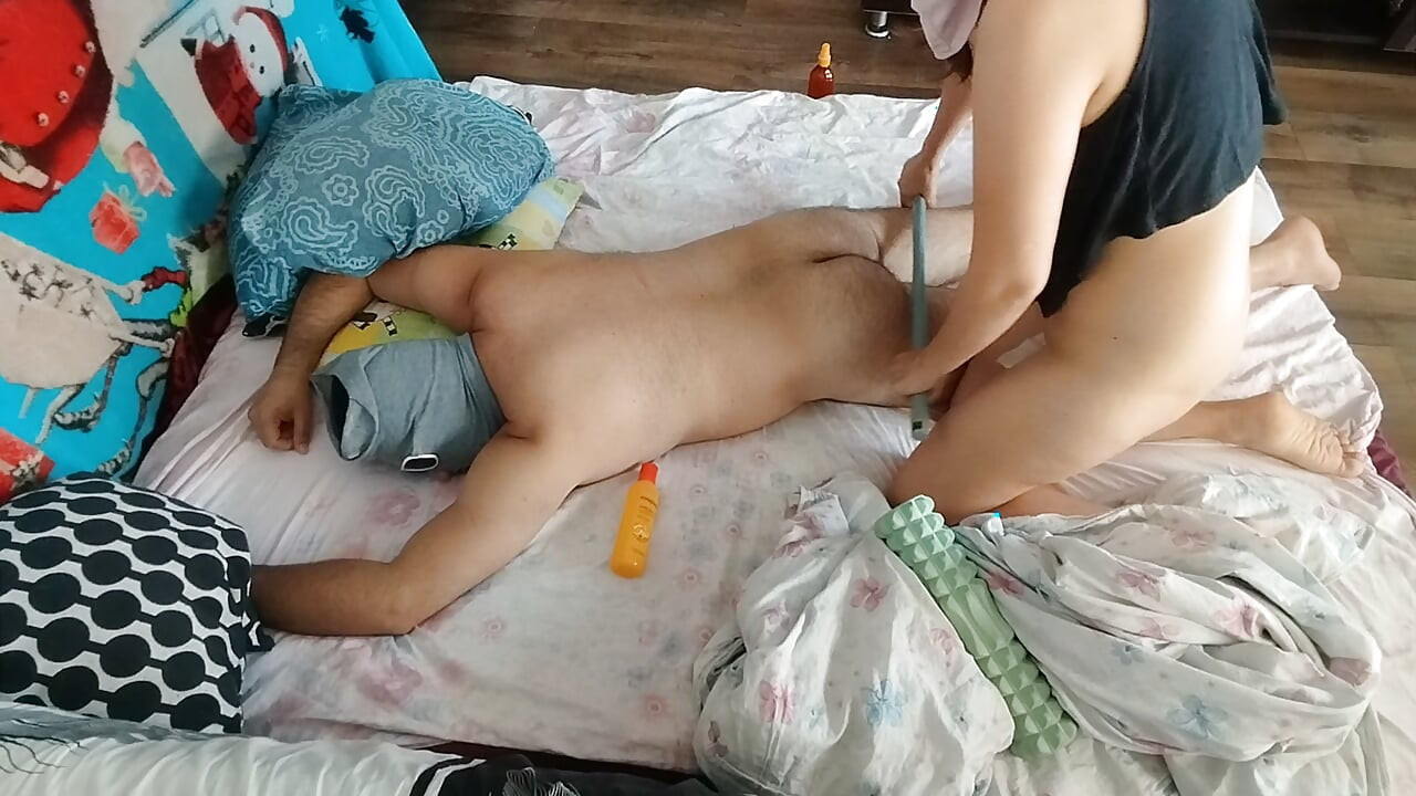 Sensual massage of a hot amateur couple with oil on the body.