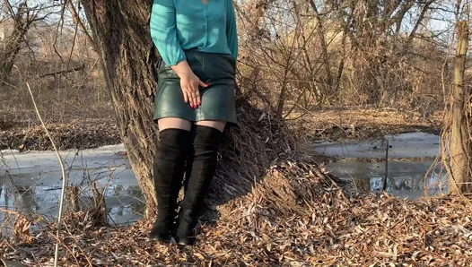 Curvy MILF in a leather skirt and long boots masturbates outdoors without taking off her pantyhose