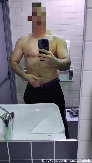 Sexy stud shows off his big soft cock in a public restroom