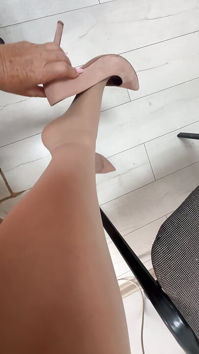 Horny mature secretary lifts her long and sexy legs in public to show her office colleagues what stockings she is wearing