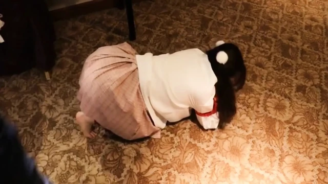 A Cute Little Dressed in a Jk Uniform Was Walking Around Barefoot on the Ground.