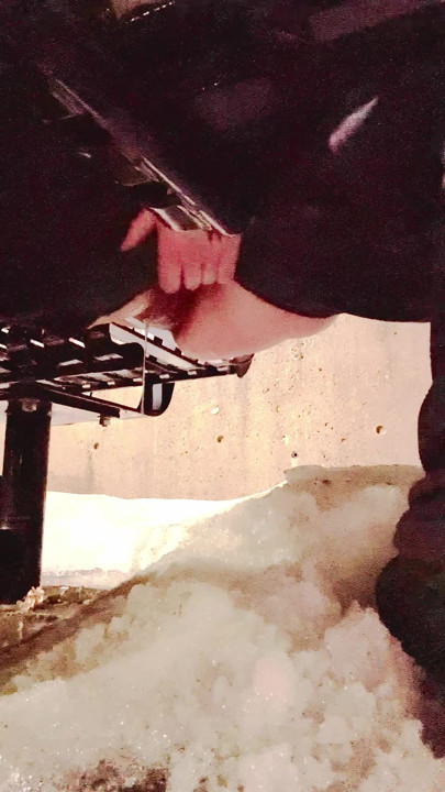 Pissing on snow sitting on a beach in public