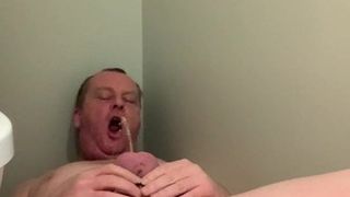 Caged cock pissing in mouth