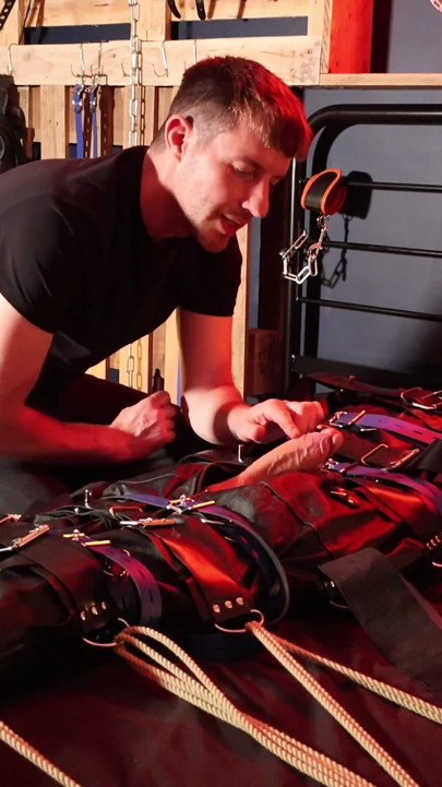 Edging the Boy in Leather Bondage but He Is Not Allowed to Orgasm
