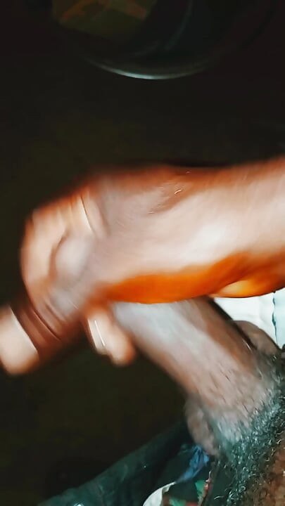 An African guy rubbing his big dick inside his room