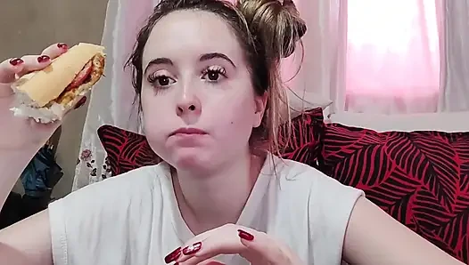 Eating an omelette sandwich with cherry tomatoes