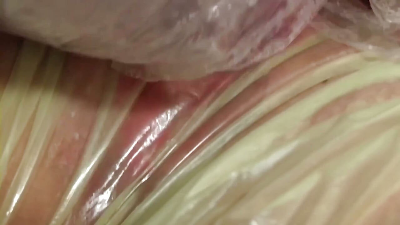 Blonde MILF in Raincoat Sucks Plastic Wrapped Cock