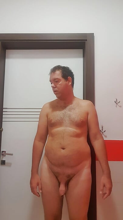 A boy completely naked in a station bathroom