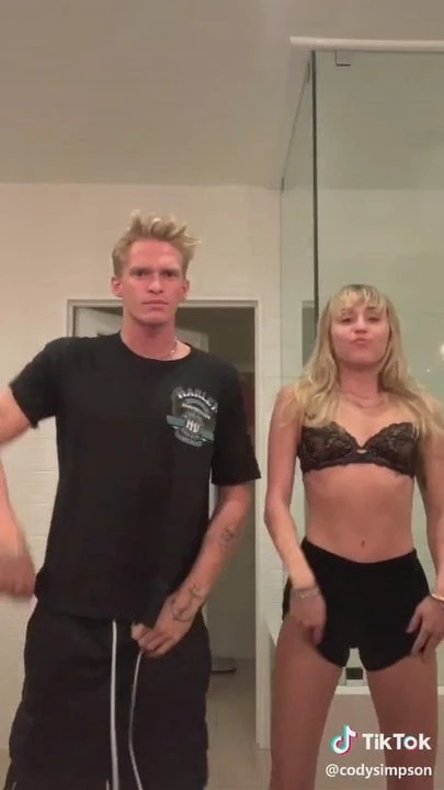 Miley Cyrus dancing and lip synching while half-dressed