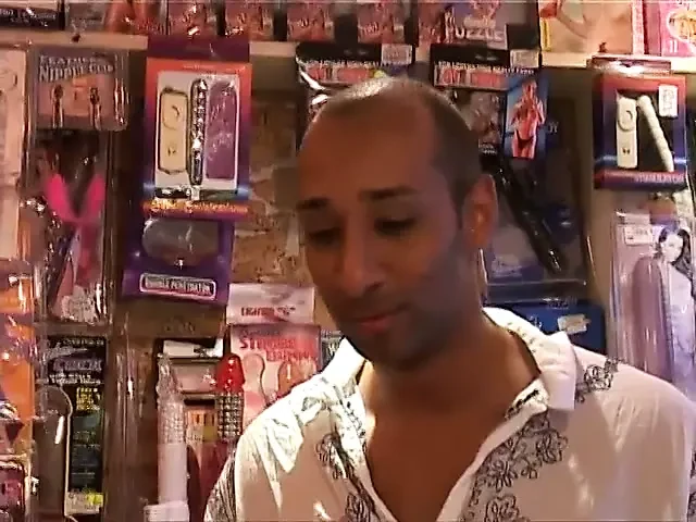 Fun in the adult book store for a big tits brunette and her black stud