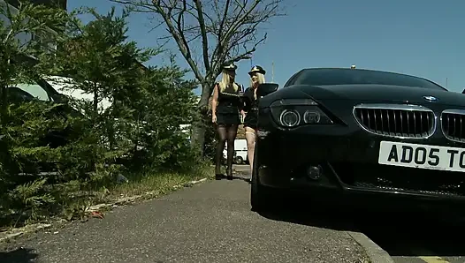 Policewoman get nailed on a desk while busty blonde is watching