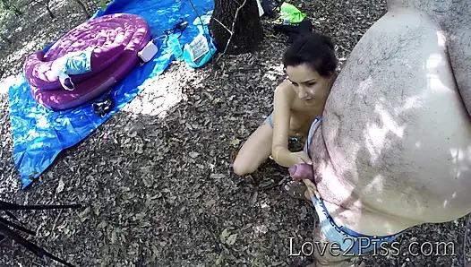 Sexy young girl helps old man empty his bladder by holding his cock