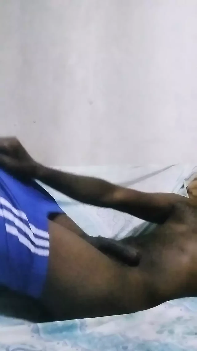 Handsome male playing with his hard dick at the sofa