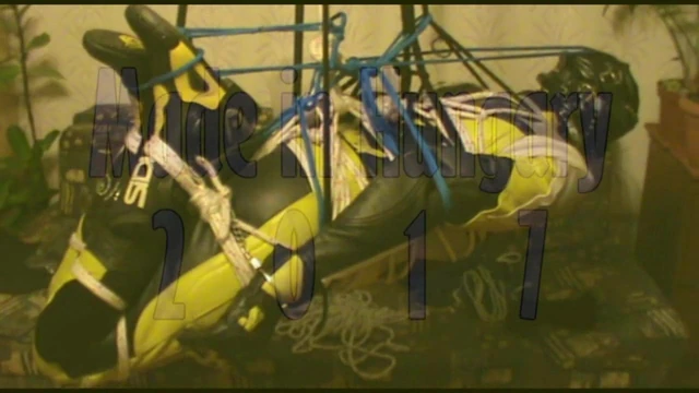 Hogtied bikerslave is suspended