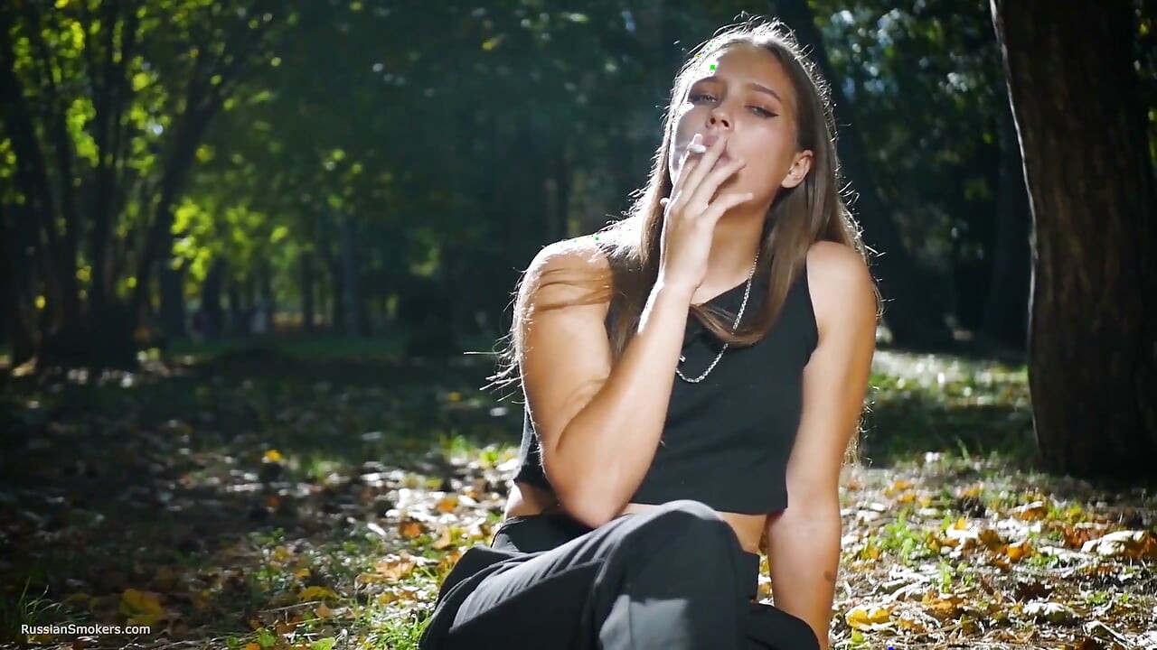 Seductive Russian Beauty Smoking Cigarette in Studio