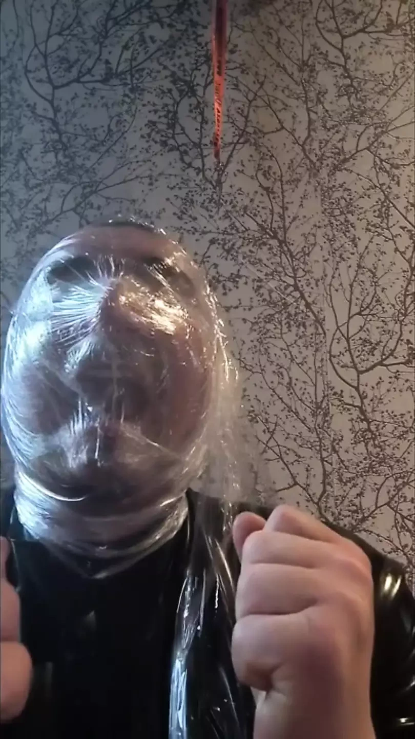 Breath play with cling film wearing latex catsuit