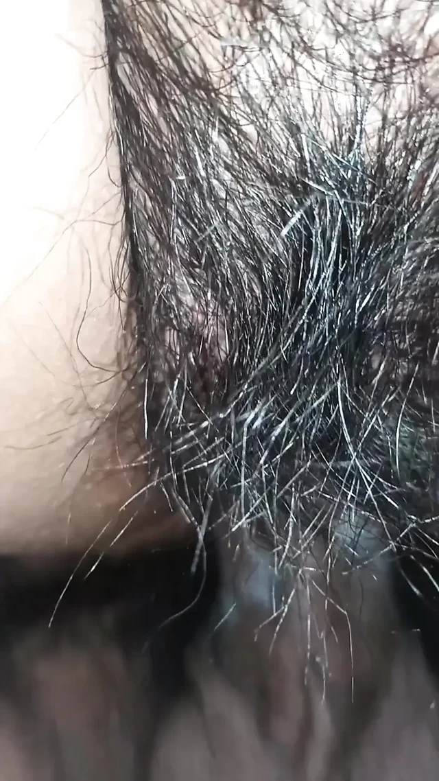 Close up view on a hairy and creamy pussy