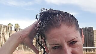 Naked swimming and smoking mature woman