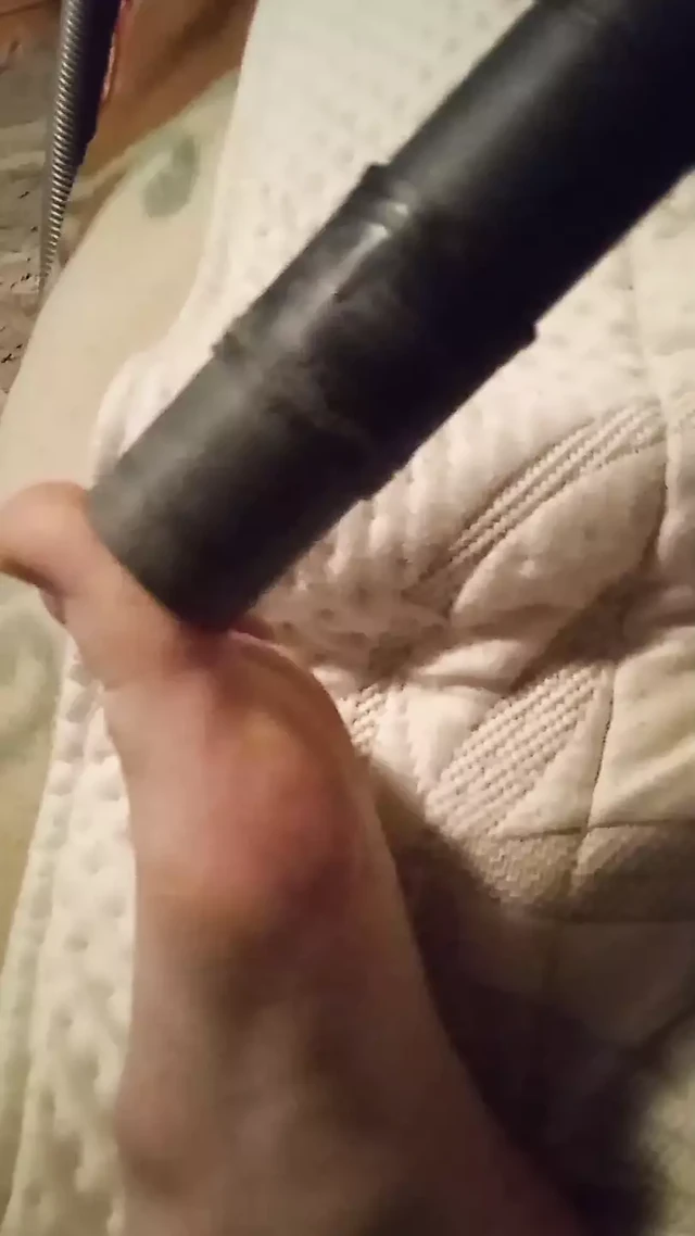 Vacuuming sock off and bare feet