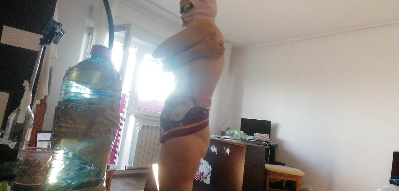 Amateur wife doing housework naked. Sexy and naughty wife trying on clothes that she cuts.