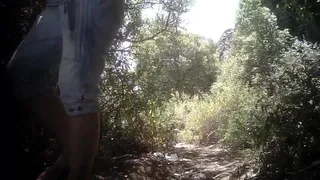 Lady peeing in the woods