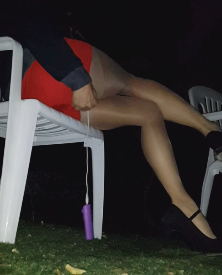 Young asian in tight red skirt, sheer pantyhose and highheels came to public park with vibrator inside. Control her with remote-
