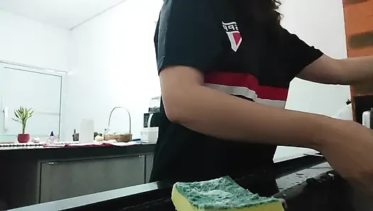 Woman teasing while washing dishes. She loves to transmit to the voyeurs on duty