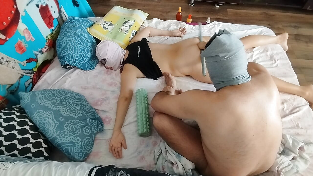 Sensual massage of a sexy couple with oil on the body.