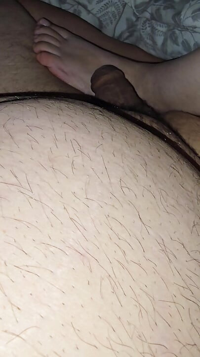 Step mom lets step son fuck her feet while sitting in bed