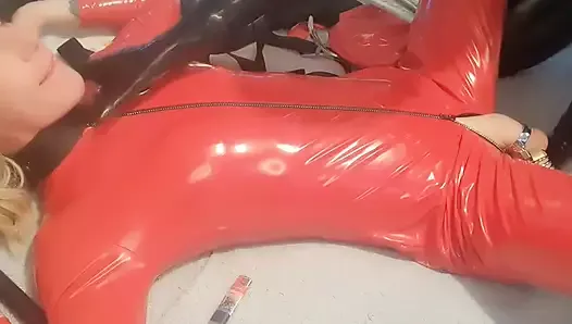 Sissy in red pvc cat suit used by rubber suited Dom
