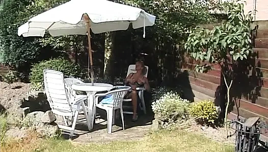 Blonde milf showing off her boobs outdoors