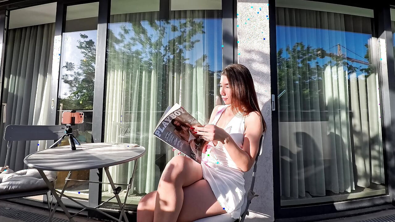 Wonderfully beautiful girl in a summer dress no panties on the balcony shows her tight shaved pussy to the neighbors