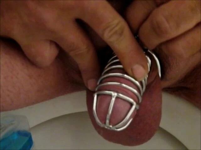 Pissing with a chastity cage.