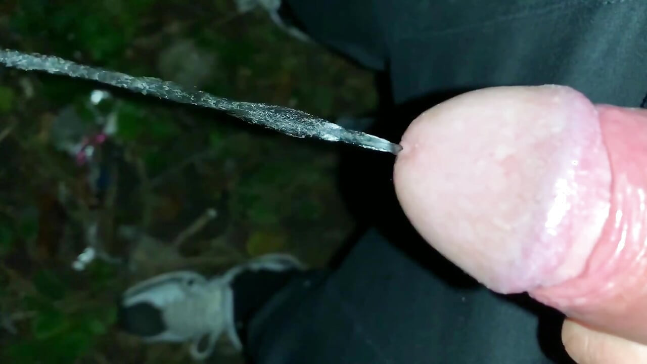 Slowmotion and Close up. Unwashed Uncut Cock Piss on the Ground Outdoor. Long Piss Stream