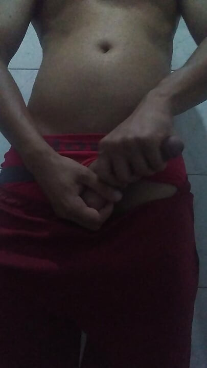 Showing off his big, thick cock in shorts and red underwear