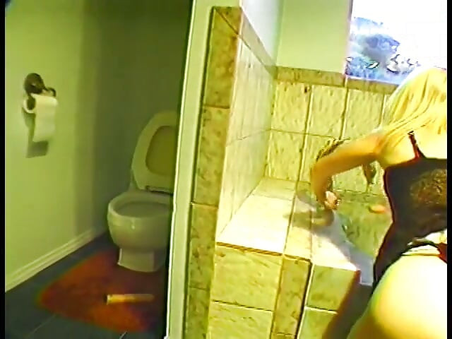 Blonde stretches her cunt with big dildo before bathroom doggy style fuck