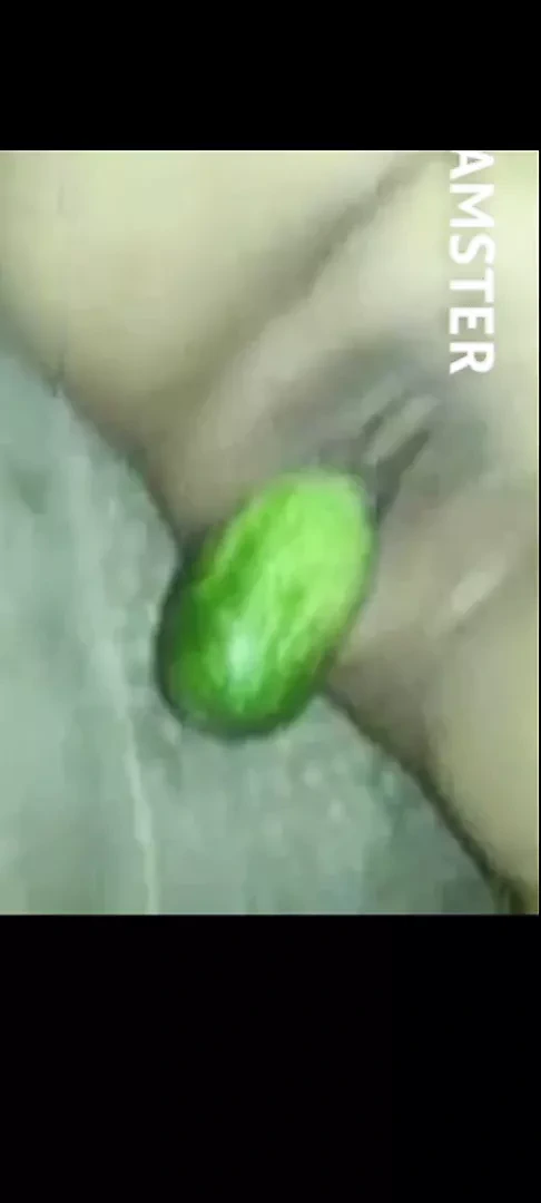 Malay girls play with cucumber