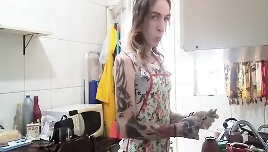 Trans housewife only in an apron in the kitchen