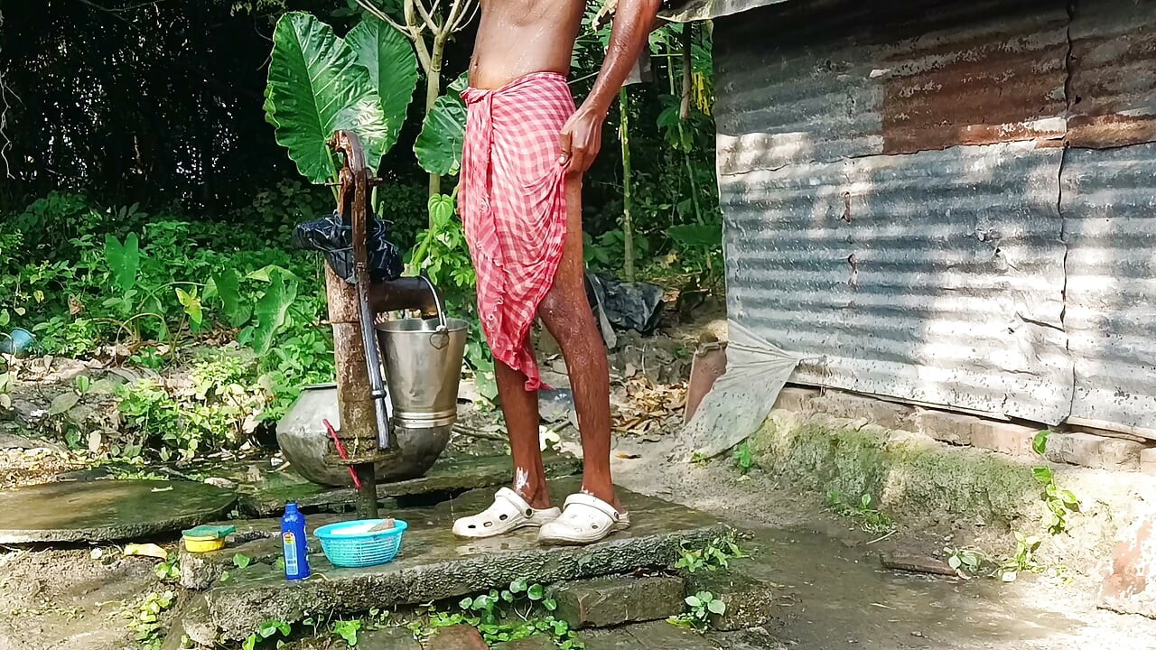 Desi young man bath Open place.