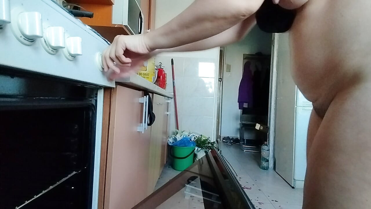Sexy wife having fun in the kitchen with roses.