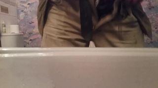 Close up pissing with a cock ring dick in the sink