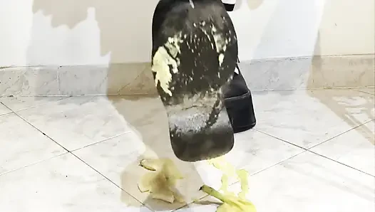 Goth crushing a banana under her shoes