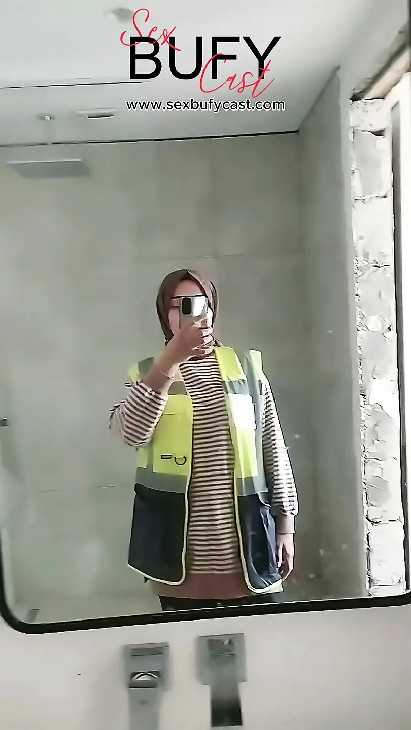 Turkish girl with headscarf who turns on the camera and puts on a show at the construction site