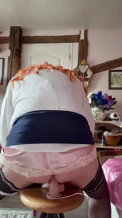 Wearing a short navy blue skirt to take a dildo