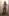 Nicki-travestito in un bellissimo Mini abito grigio, calze nere e stivali plateau