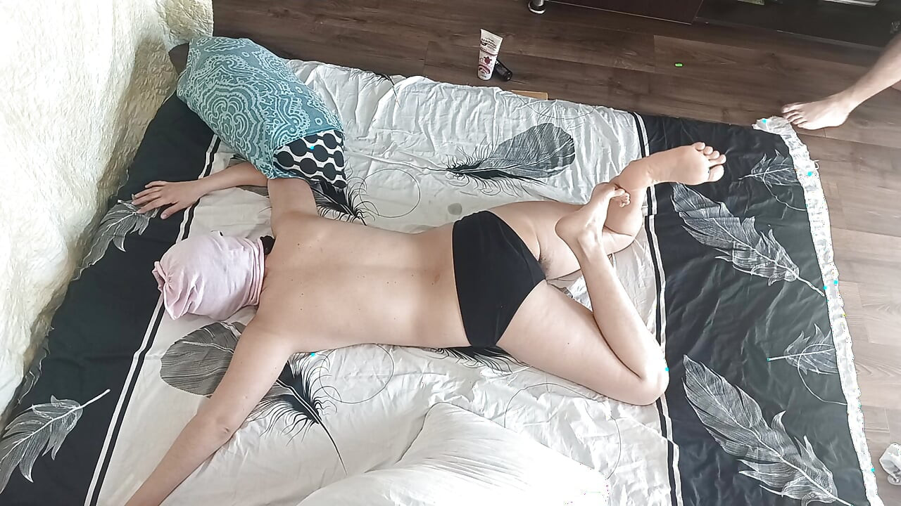 Sensual massage of a hot couple with oil on the body. Foreplay in the bedroom with an amateur couple.