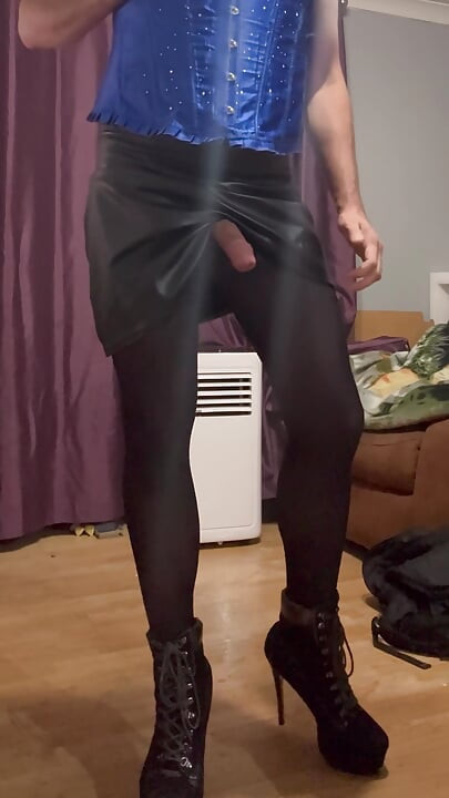 Maninboots edging dressed in blue corset, black skirt and high heel ankle boots. with multiple cumshots