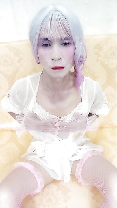 Oanh Le transgender wearing sexy porn clothes playing with a fake can