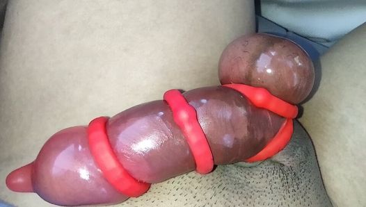 Asian jacking off his red rocket!  His cock engorged using cock rings and a condom.